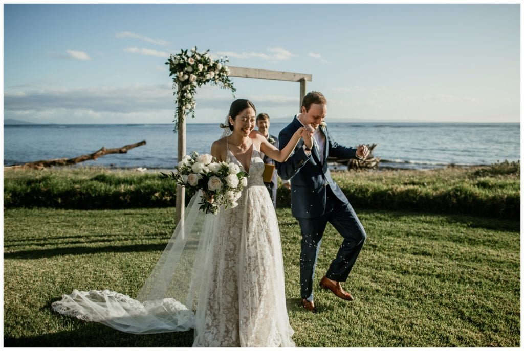 Olowalu Wedding Elopement Photographer picture of bride and groom getting married beside the ocean under ceremony arch