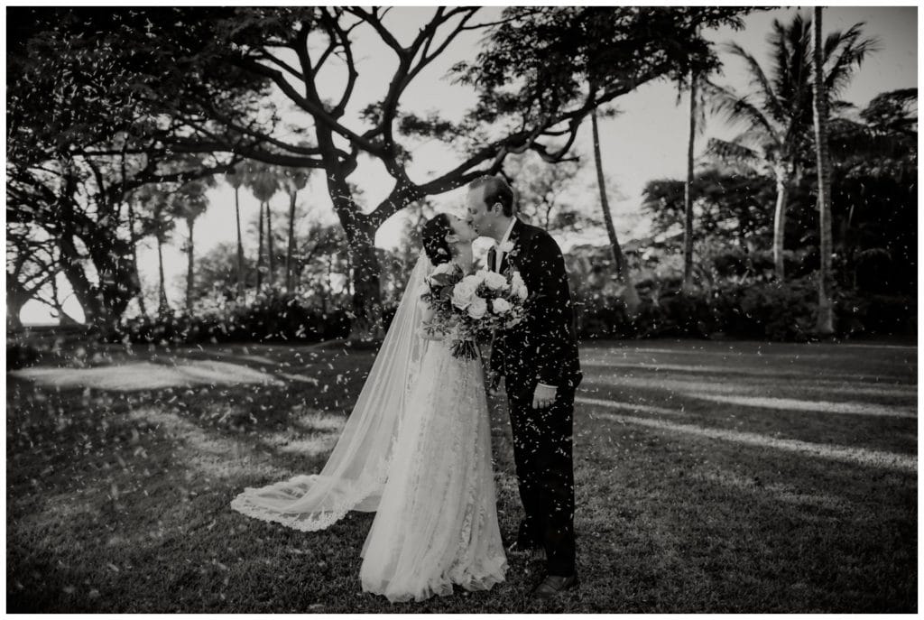 Olowalu Wedding Elopement Photographer picture of bride and grooms kissing and rice being thrown in celebration on their wedding day