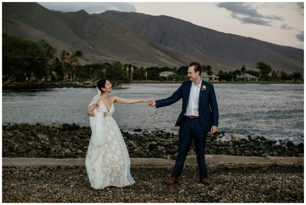 Olowalu Wedding Elopement Photographer picture of bride and groom on their wedding day holding hands and dancing