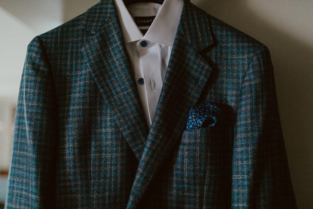 Detail shot of shirt and plaid coat hanging