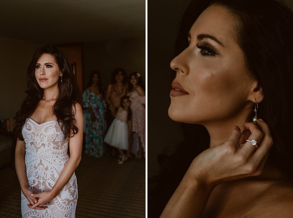 Portrait if Bride looking out window with friends and family looking at her