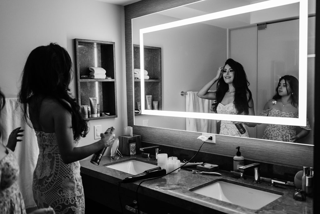 B&W Bride getting her hair done using hairspray