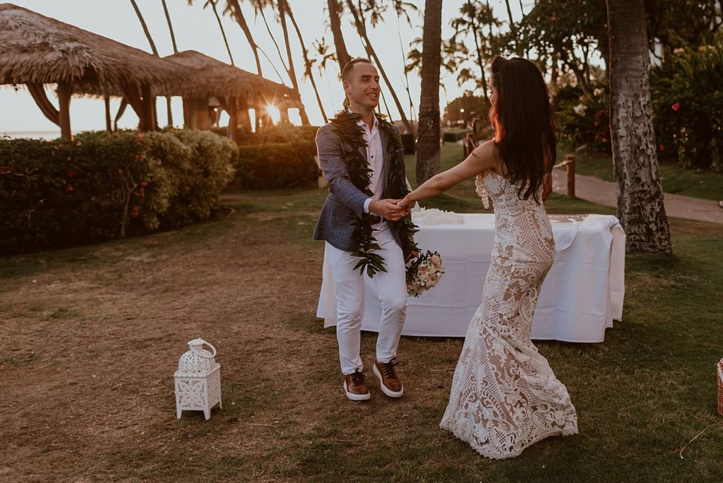 Bride and Groom dancing outside with the sunsetting