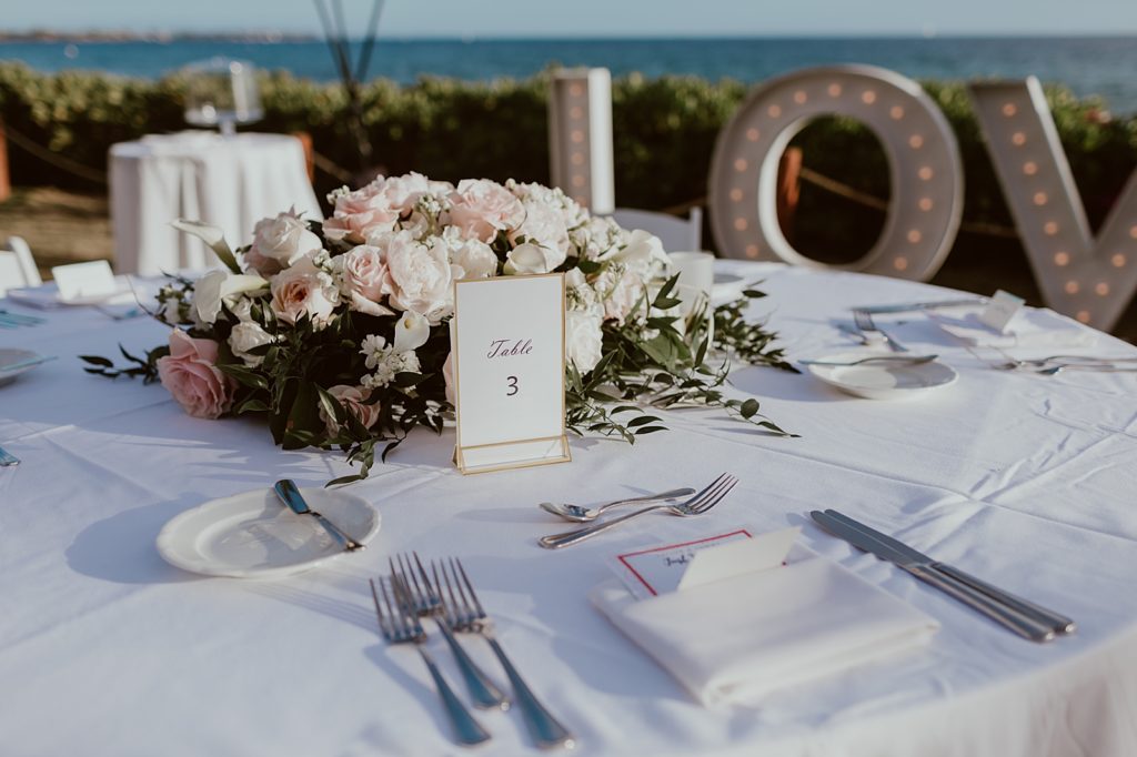 Detail shot of Reception table with flower centerpiece and table number