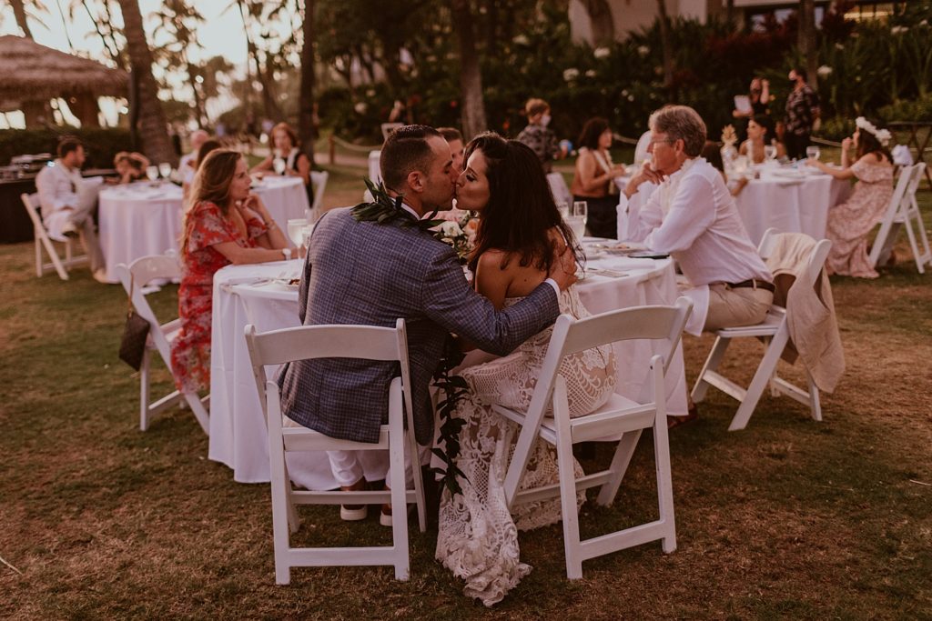 Bride and Groom kissing at Reception table