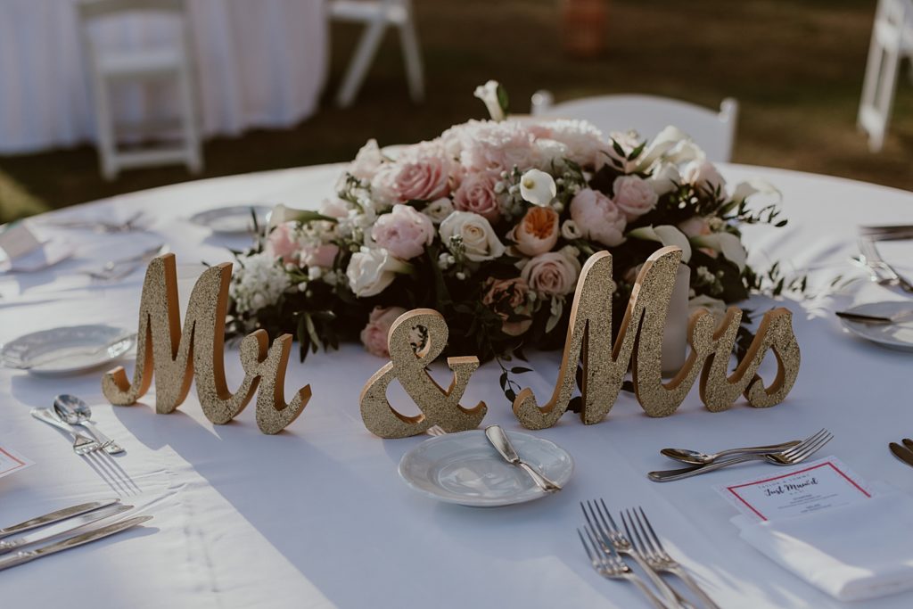 Detail shot Mr and Mrs decor with floral centerpiece