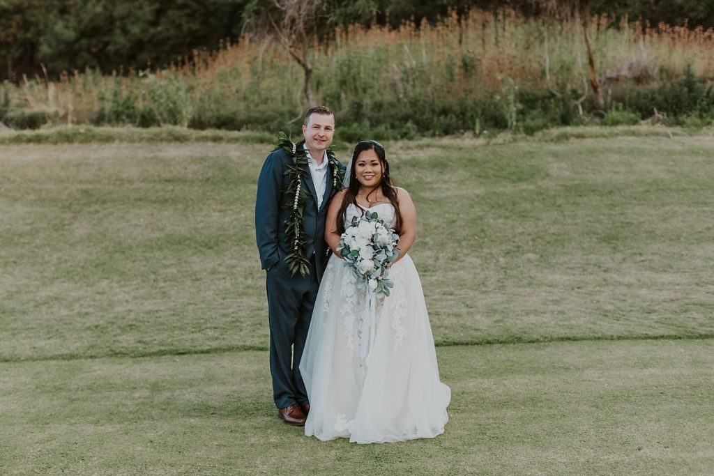 Bride and Groom next to each other of golf course