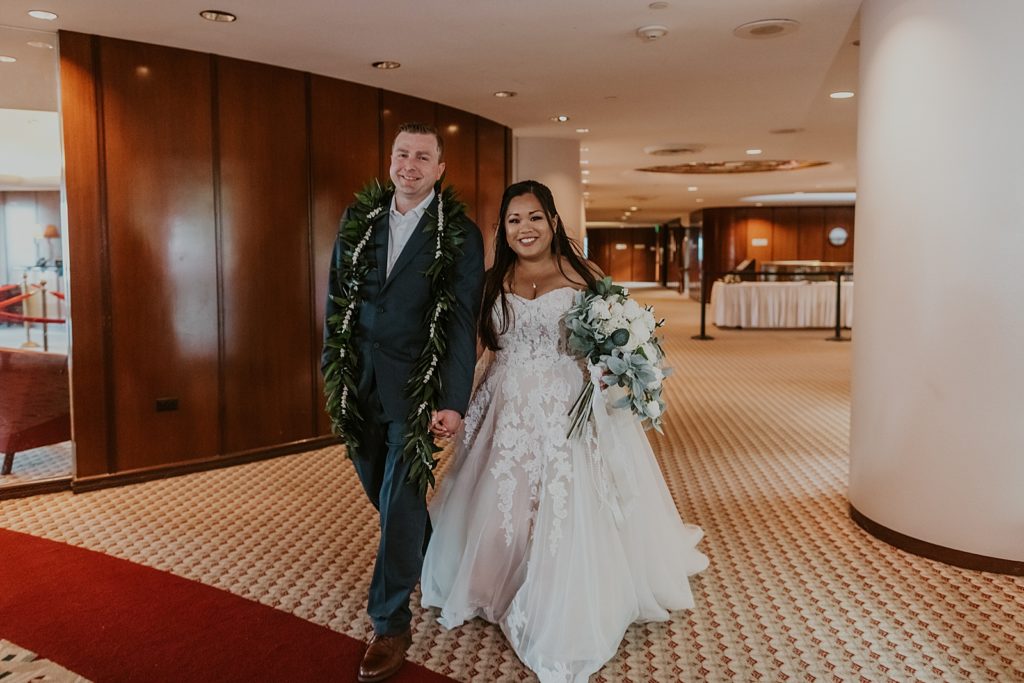 Bride and Groom holding hands entering Reception building