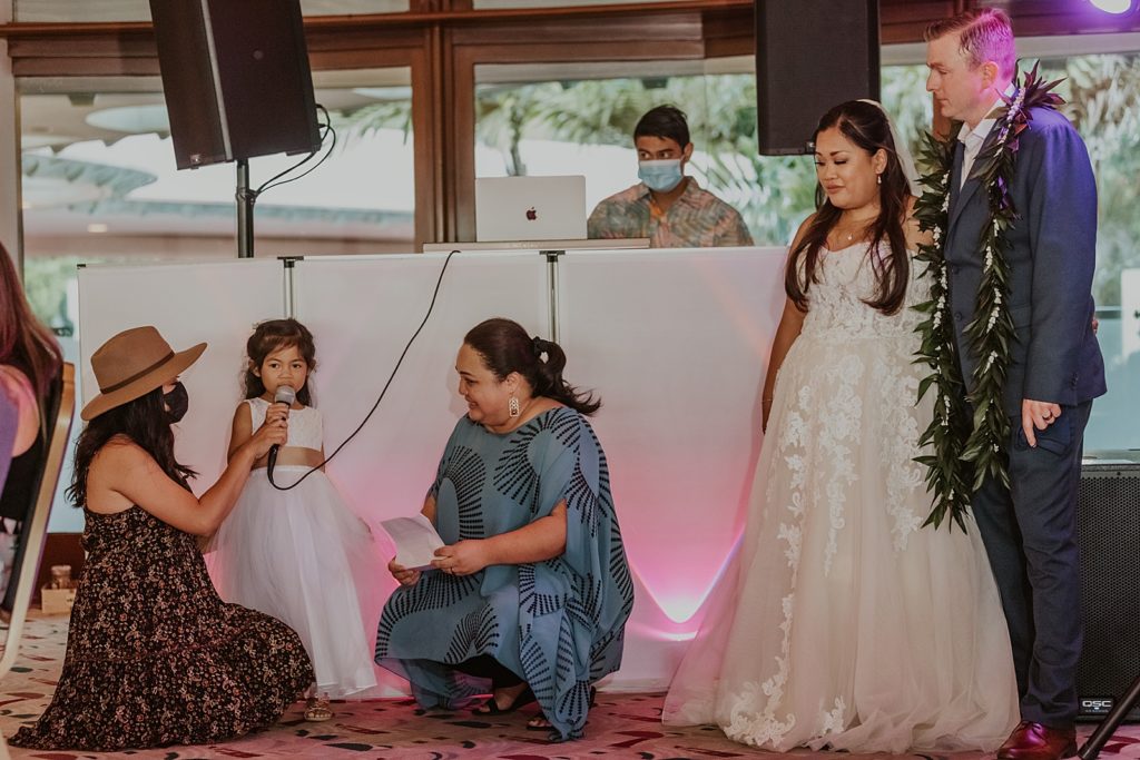 Bride and Groom by DJ stand listening to flower girl speech Reception
