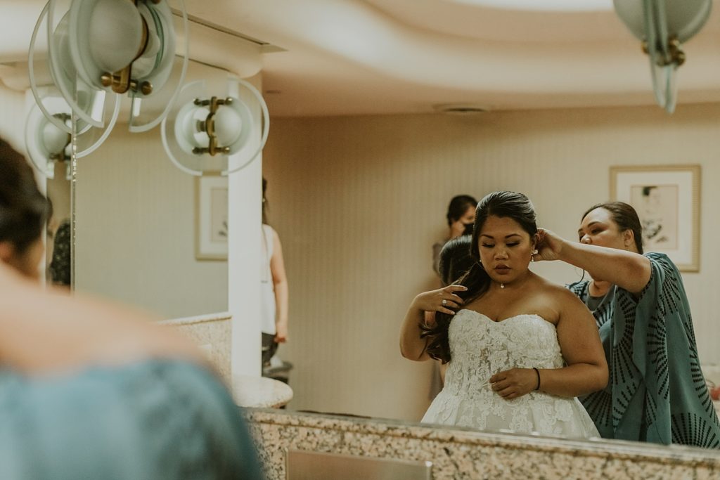 Bride getting hair done by hair stylist Getting ready