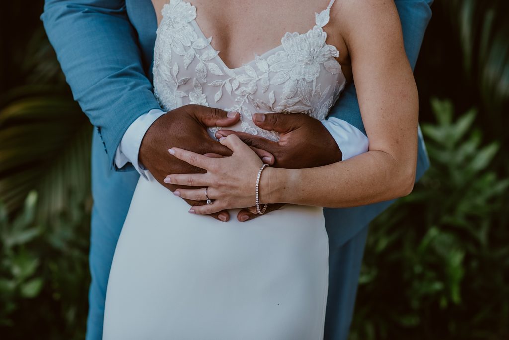 Closeup of Groom holding Bride
