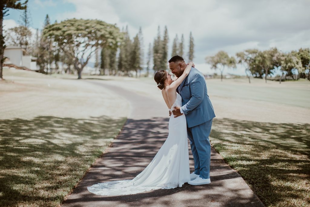 Bride and Groom holding each other on sidewalk