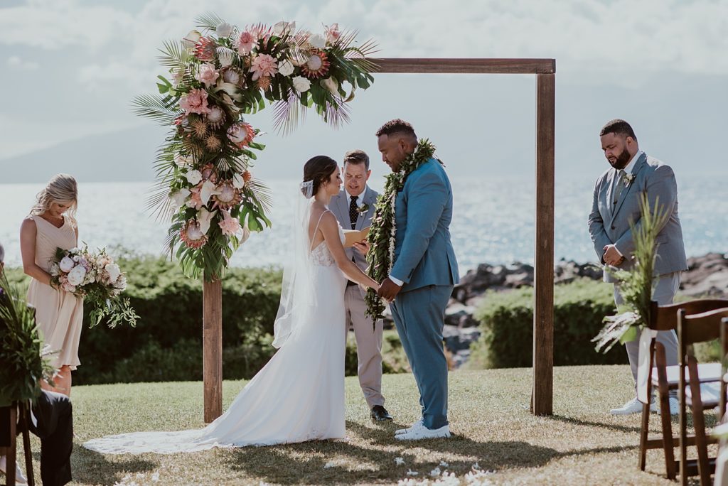 Bride and Groom bowing heads during prayer for Ceremony