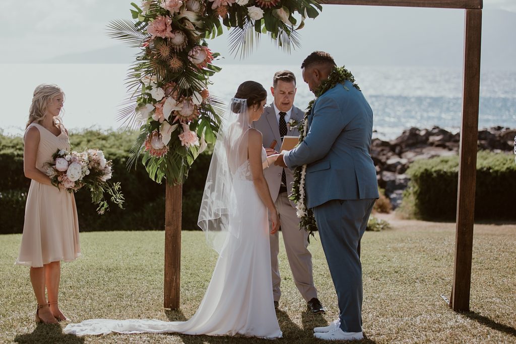 Groom putting ring on Bride during Ceremony