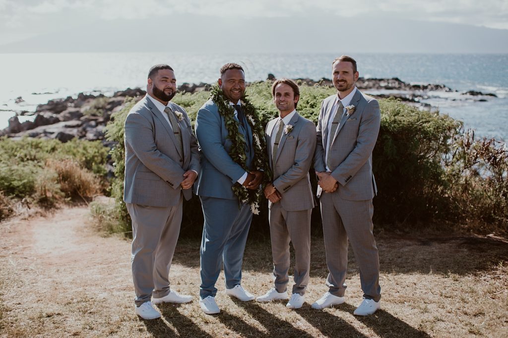 Groom with groomsmen by the ocean water