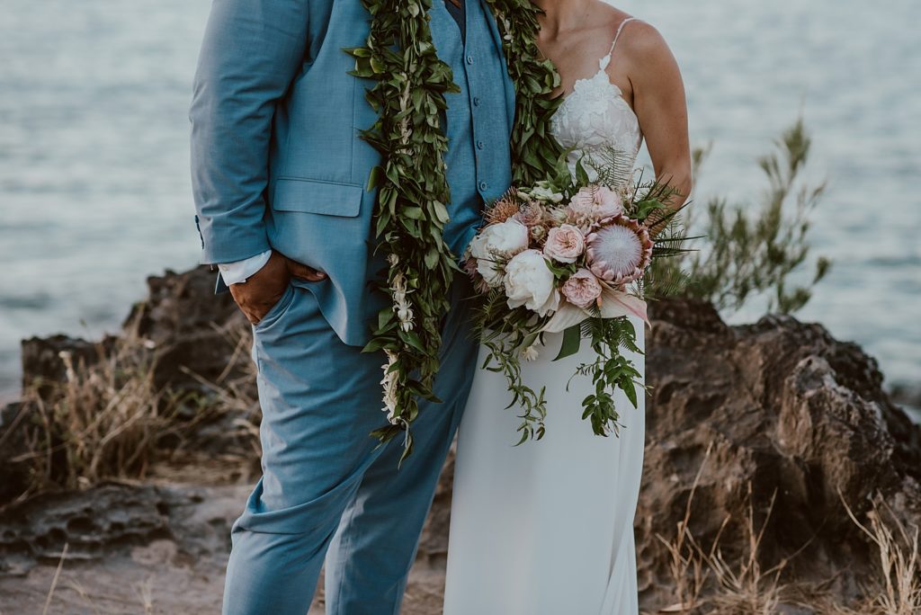 Closeup of Bride and Groom's outfits and bouquet