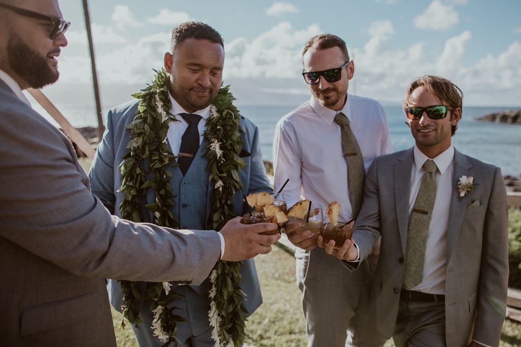 Groom and Groomsmen cheering their tropical pineapple drinks