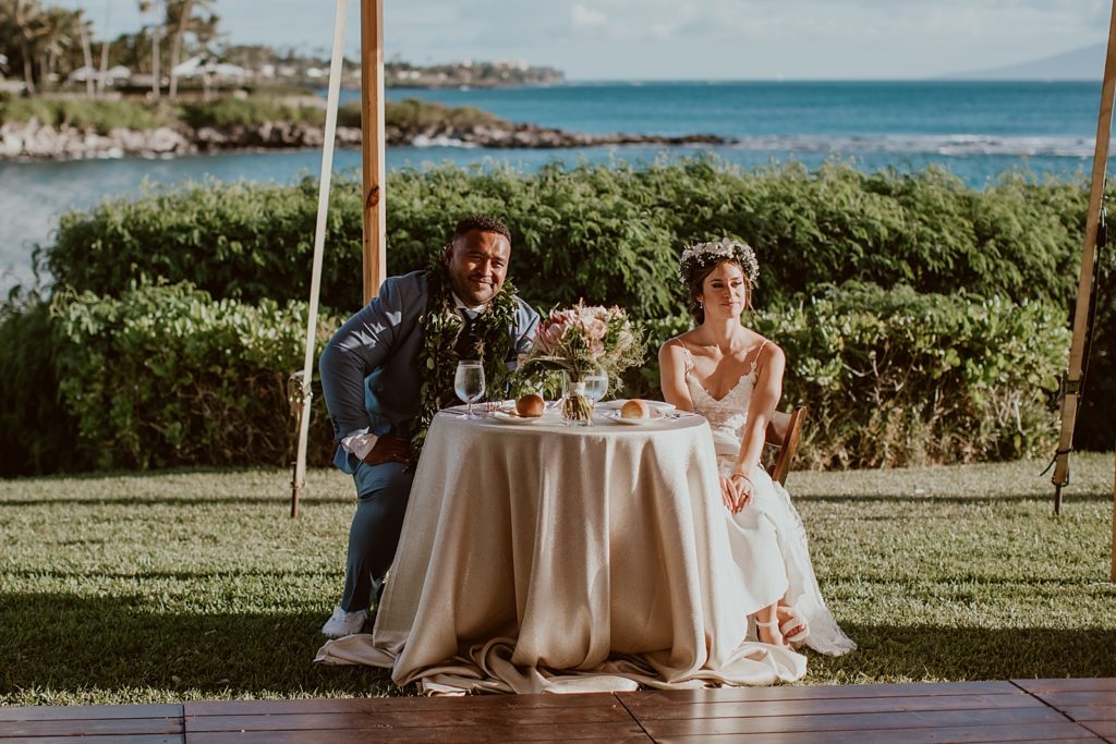 Bride and Groom sitting at the sweetheart table