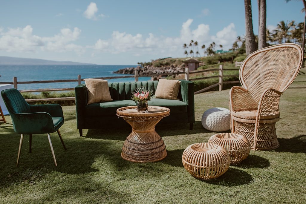 Detail shot of outdoor area with emerald couch and chair and weaved furniture