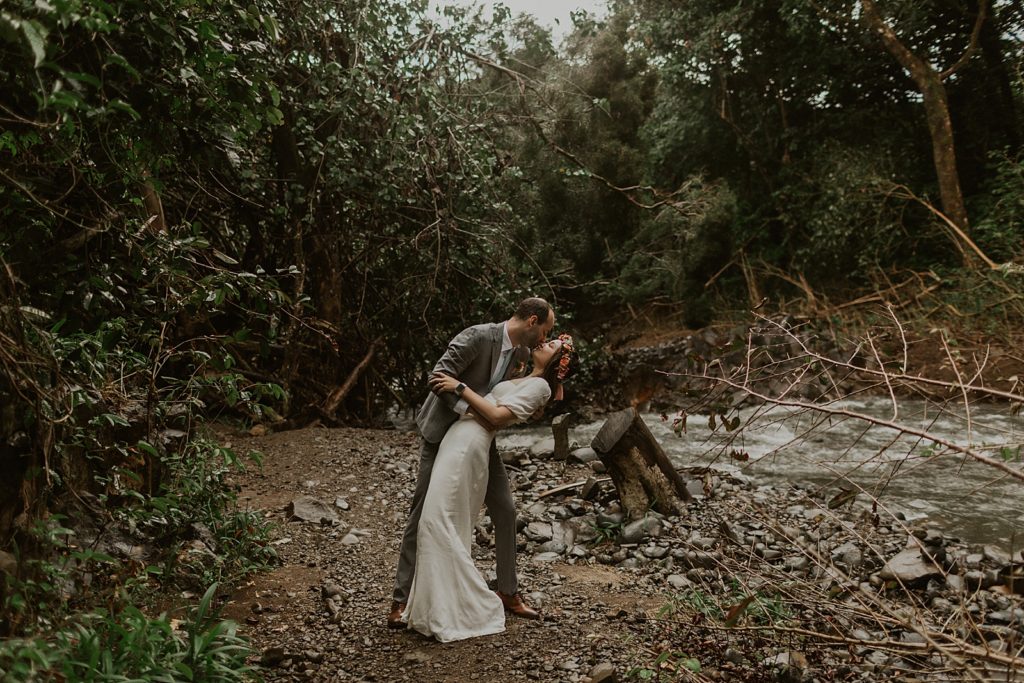 Bride and Groom dipping and kissing in forest