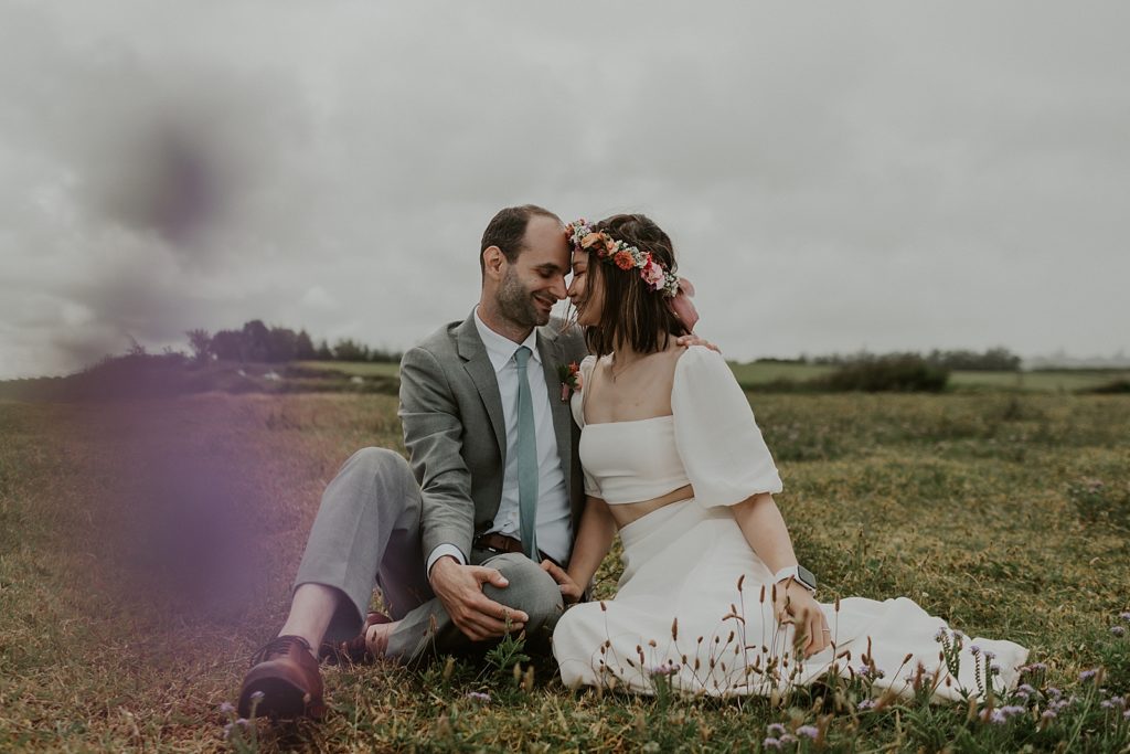 Bride and Groom sitting and resting their heads on each other
