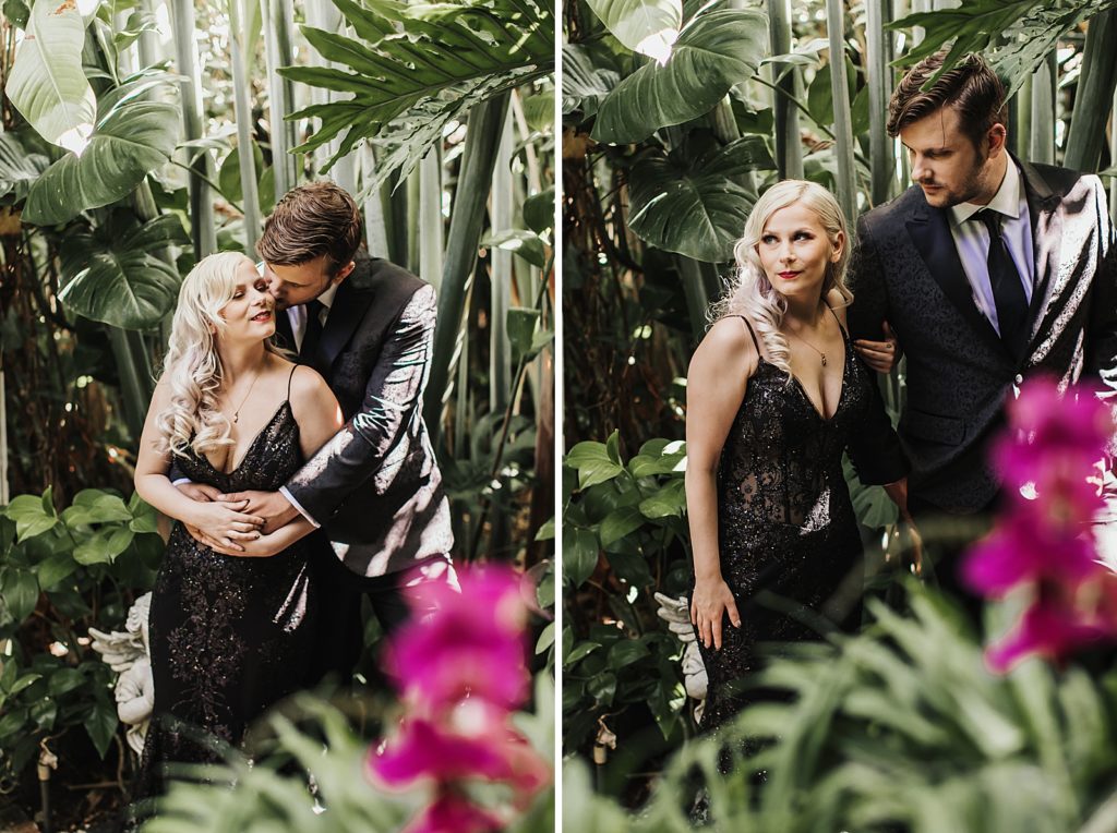 Groom holding Bride and nuzzling with greenery surrounding them