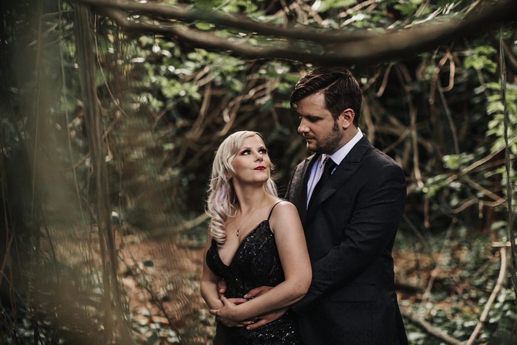 Groom holding Bride out in the forest