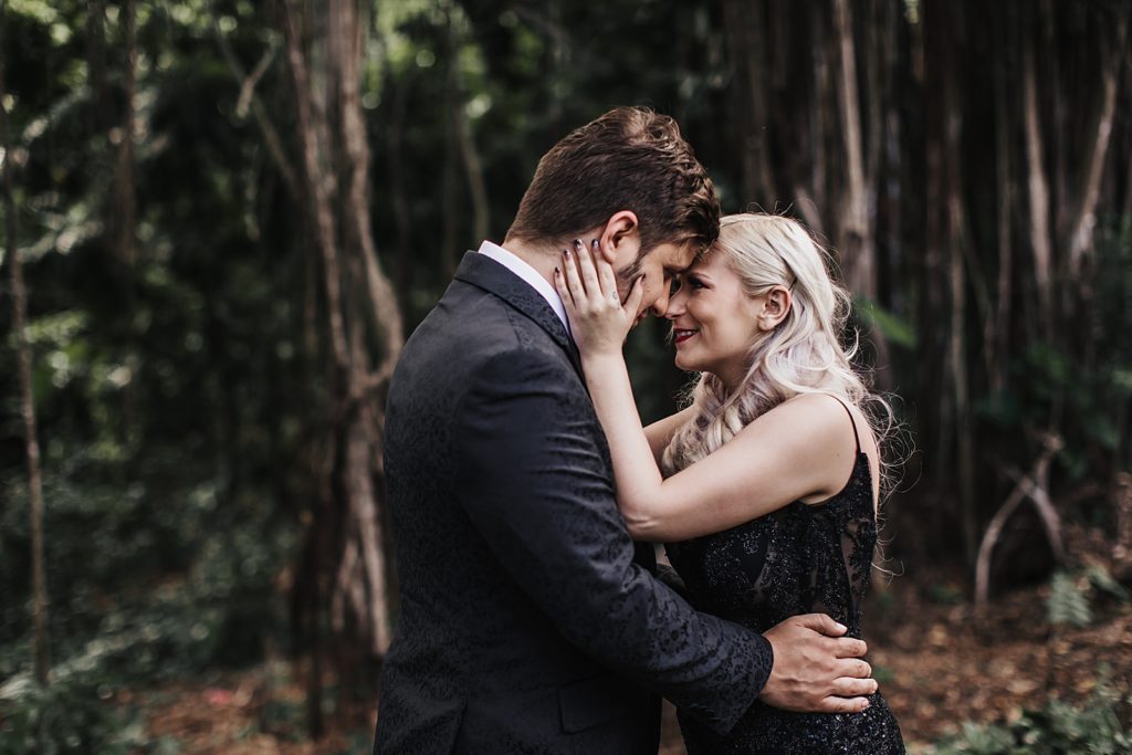 Bride and Groom resting their heads on each other and holding each other