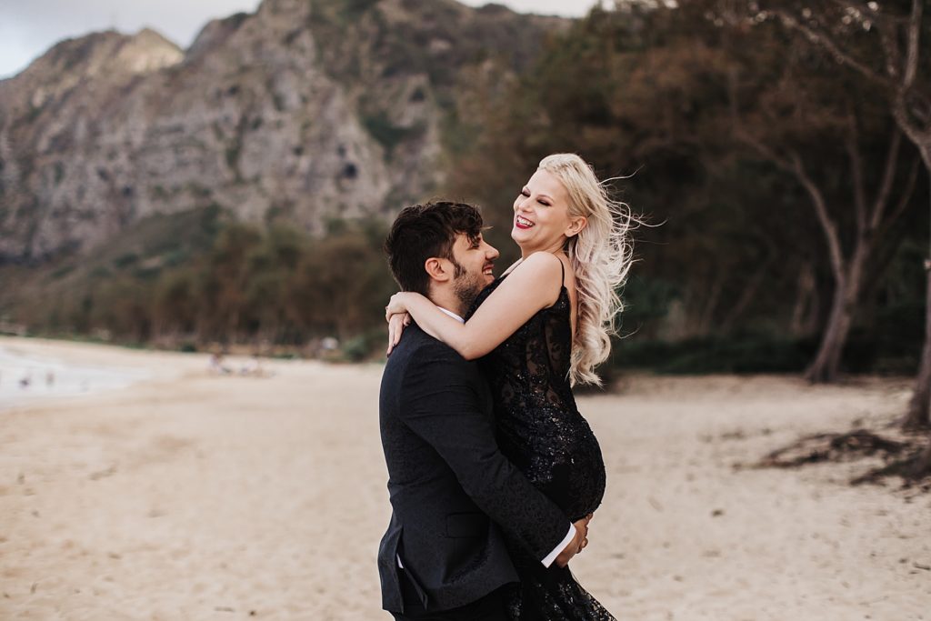 Groom holding Bride on the beach