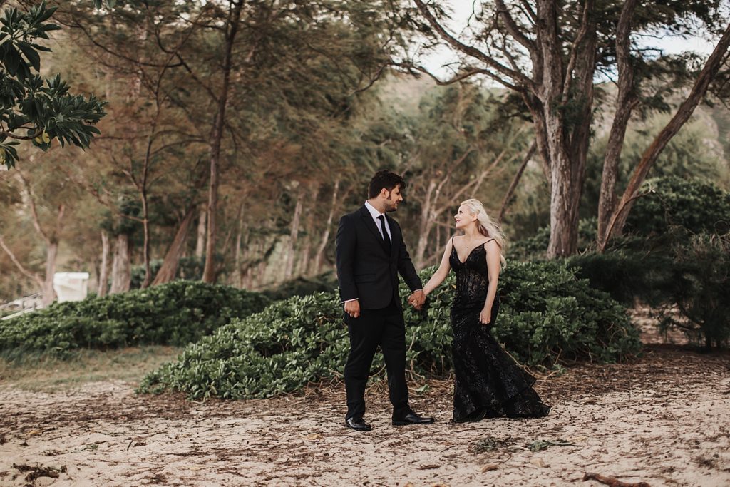 Bride and Groom holding hands in forest