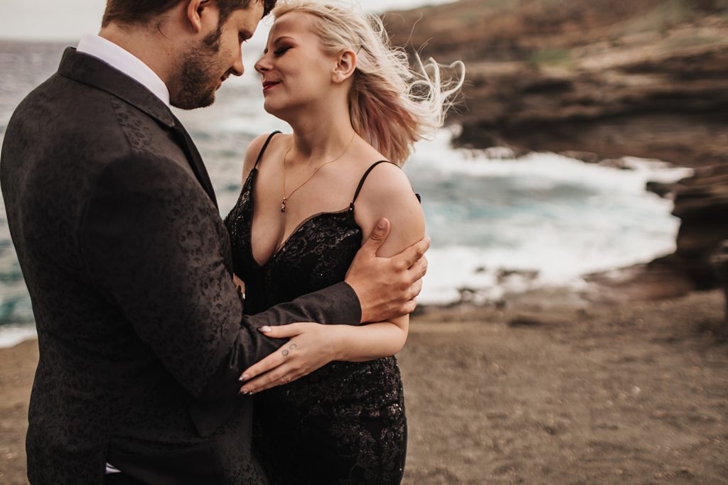 Bride and Groom holding each other by the ocean