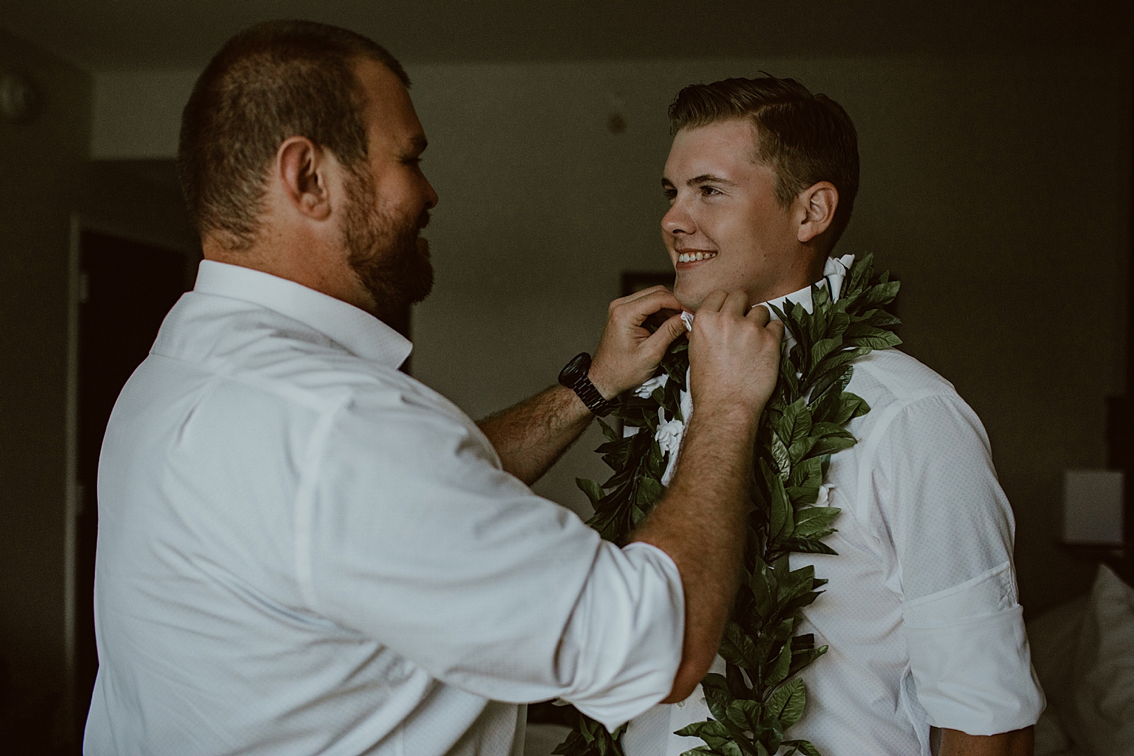 Best man helping Groom getting ready in hotel