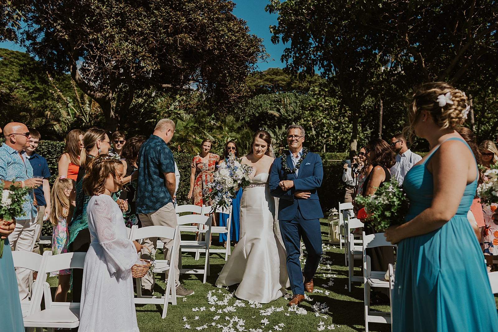 Bride and Father entering ceremony with everyone standing outdoor wedding