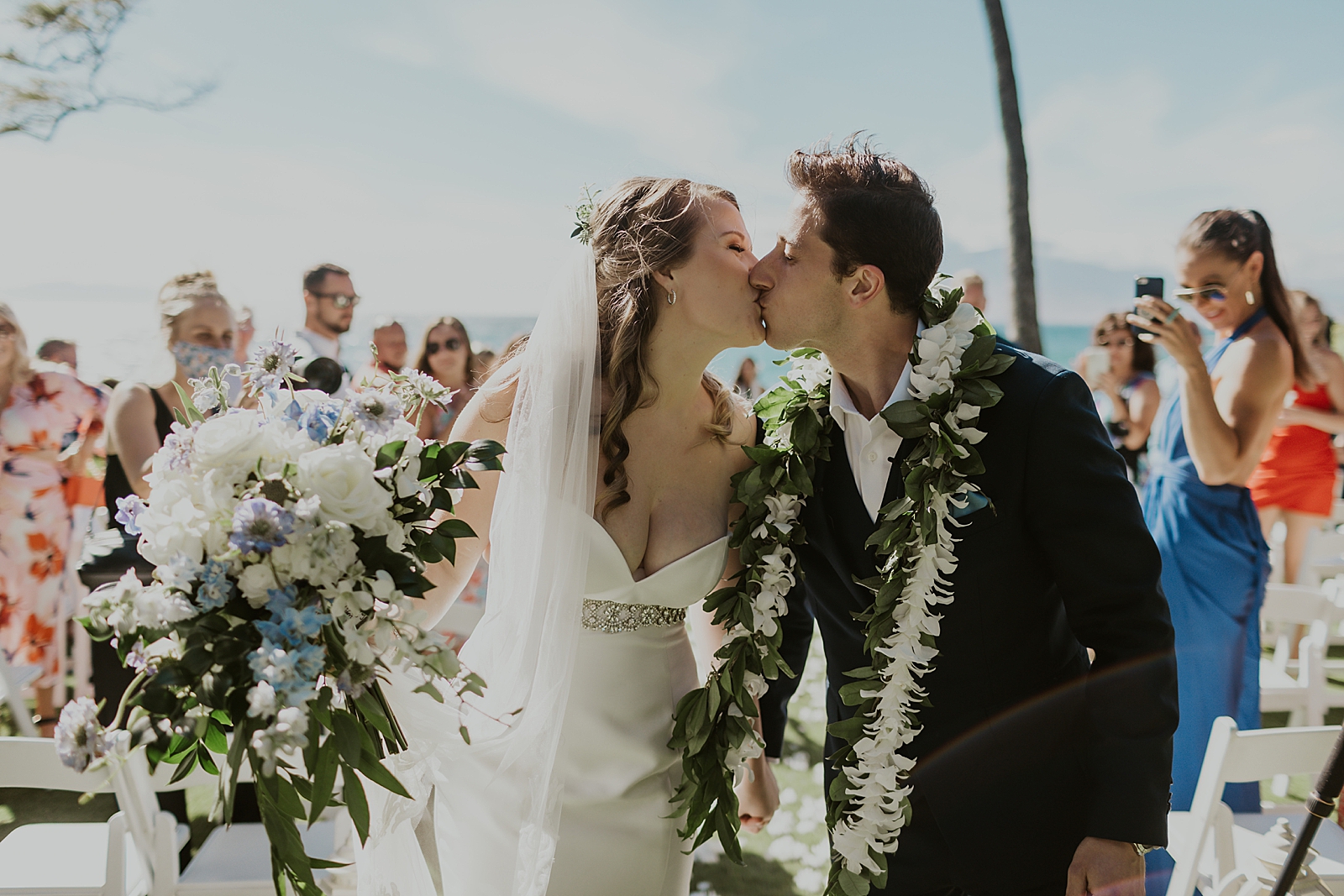 Bride and Groom kissing during Ceremony exit