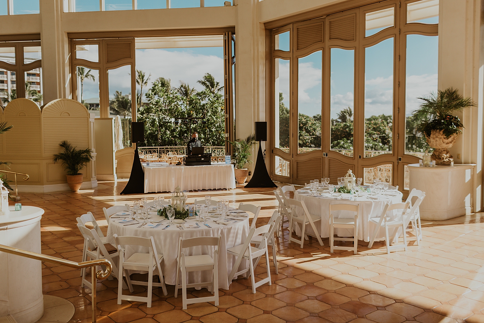 Detail shot of Reception area with white round tables and folding chairs