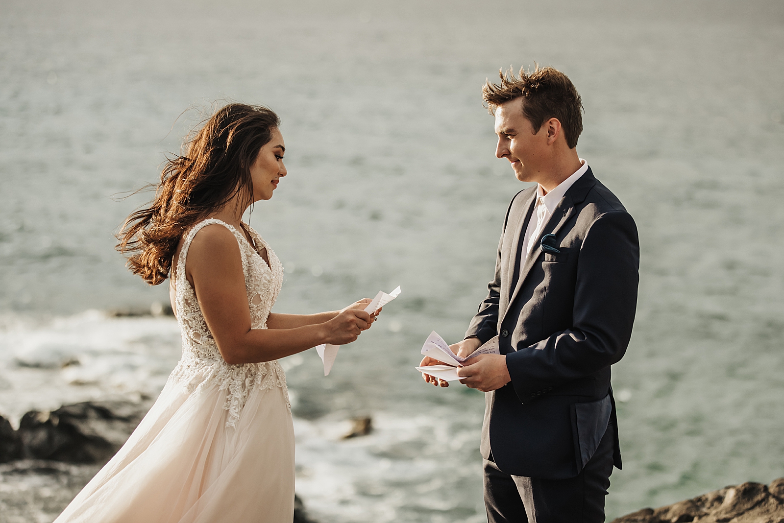 Bride and Groom exchanging vows next to the sea