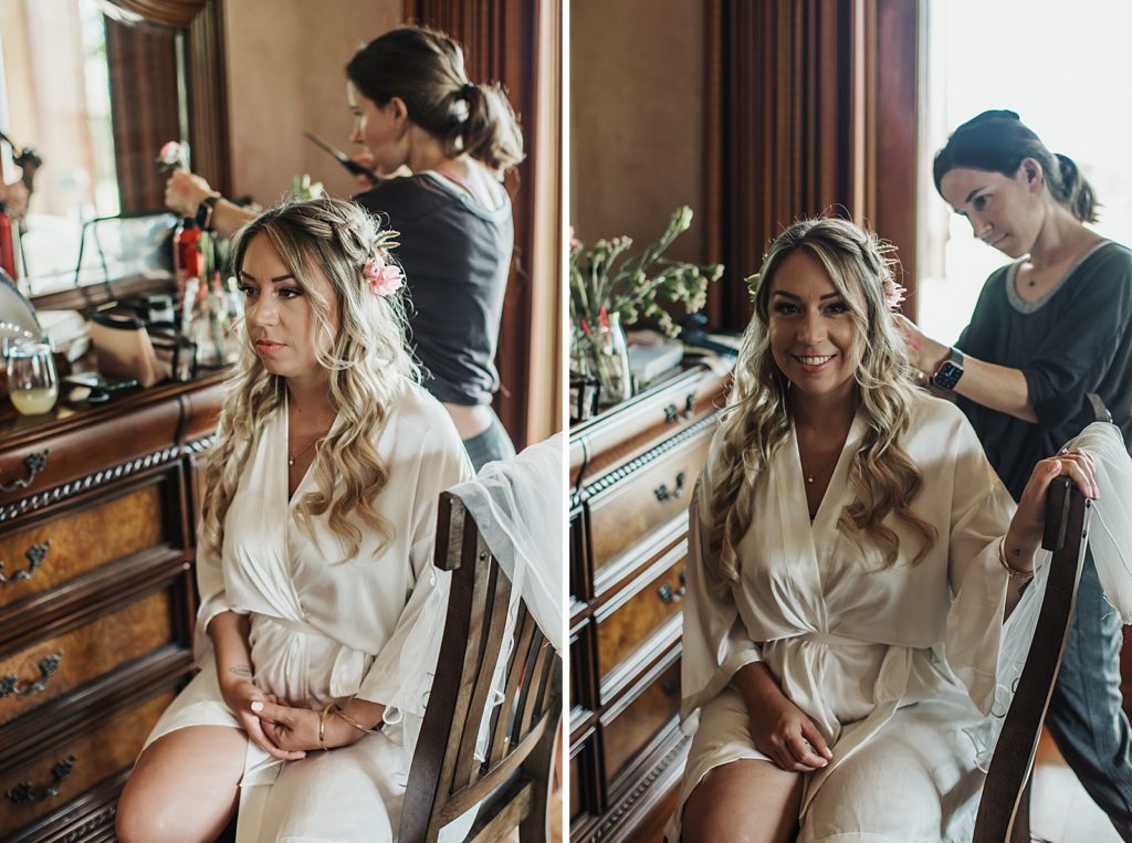 Bride getting hair done by stylist getting ready