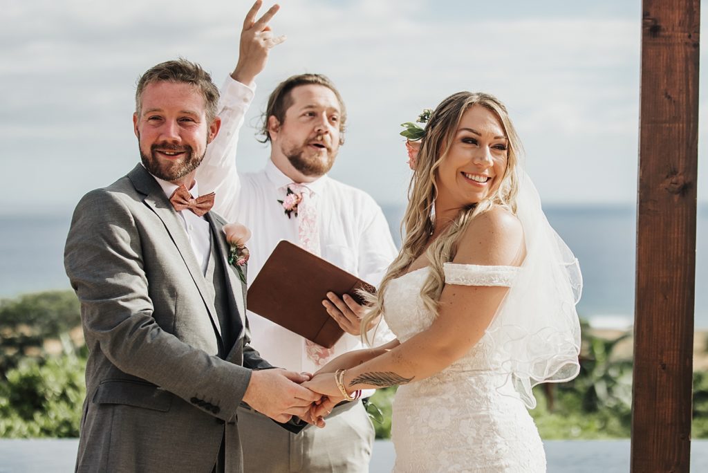 Bride and Groom looking at audience during outdoor Ceremony