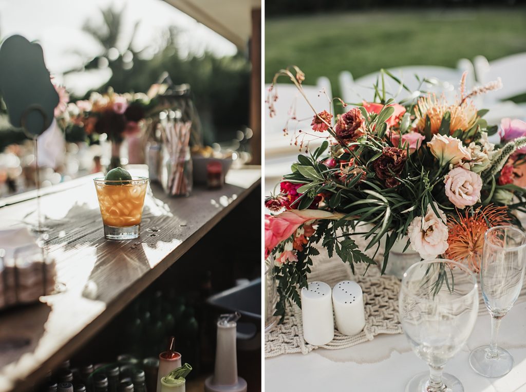 Detail shot of cocktail bar with lime ine glass and flower centerpieces on Reception table