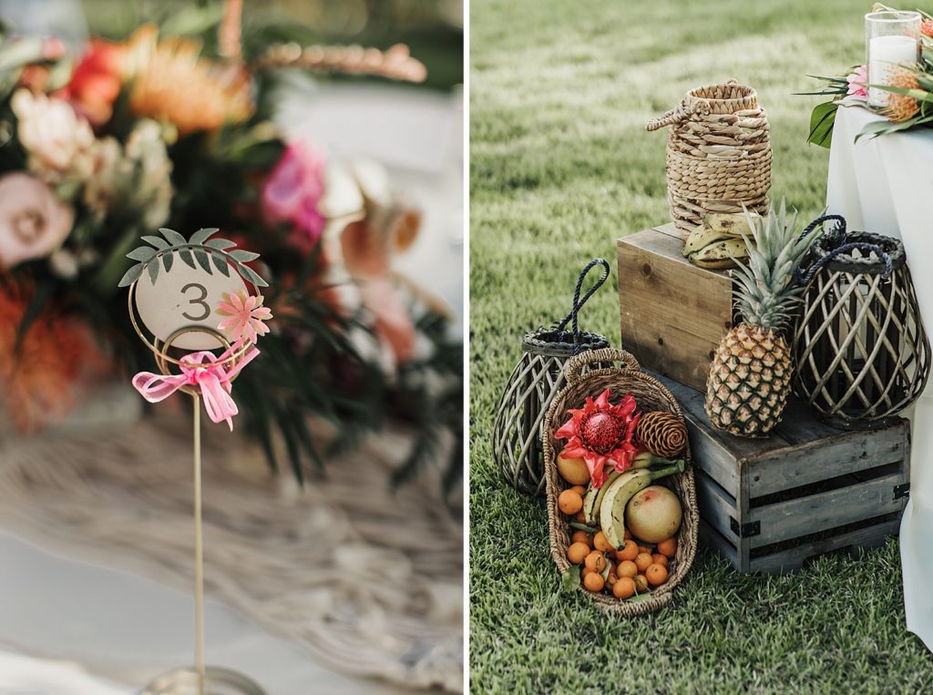 Detail shot of table number and fruit by sweetheart table