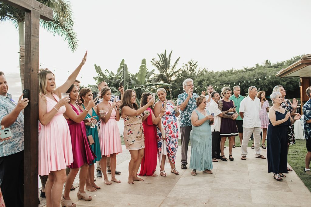 Guests celebrating as Bride and Groom entering Ceremony together