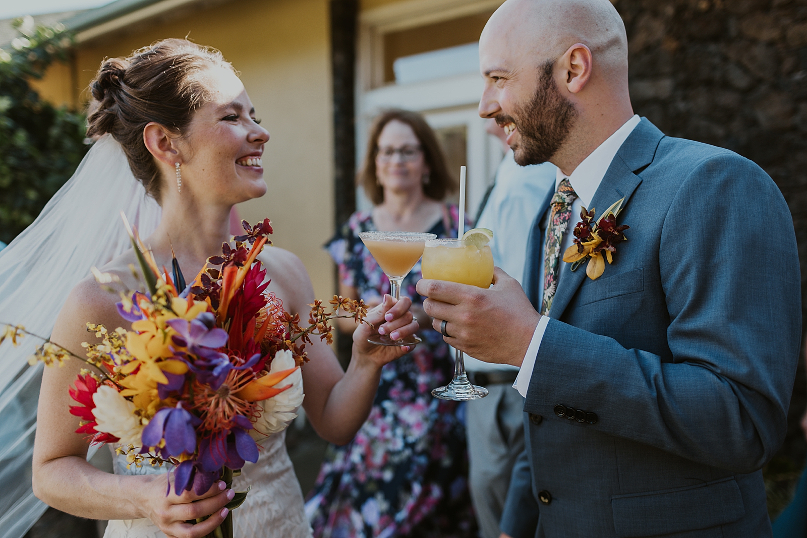 Bride and Groom cheering cocktails outside