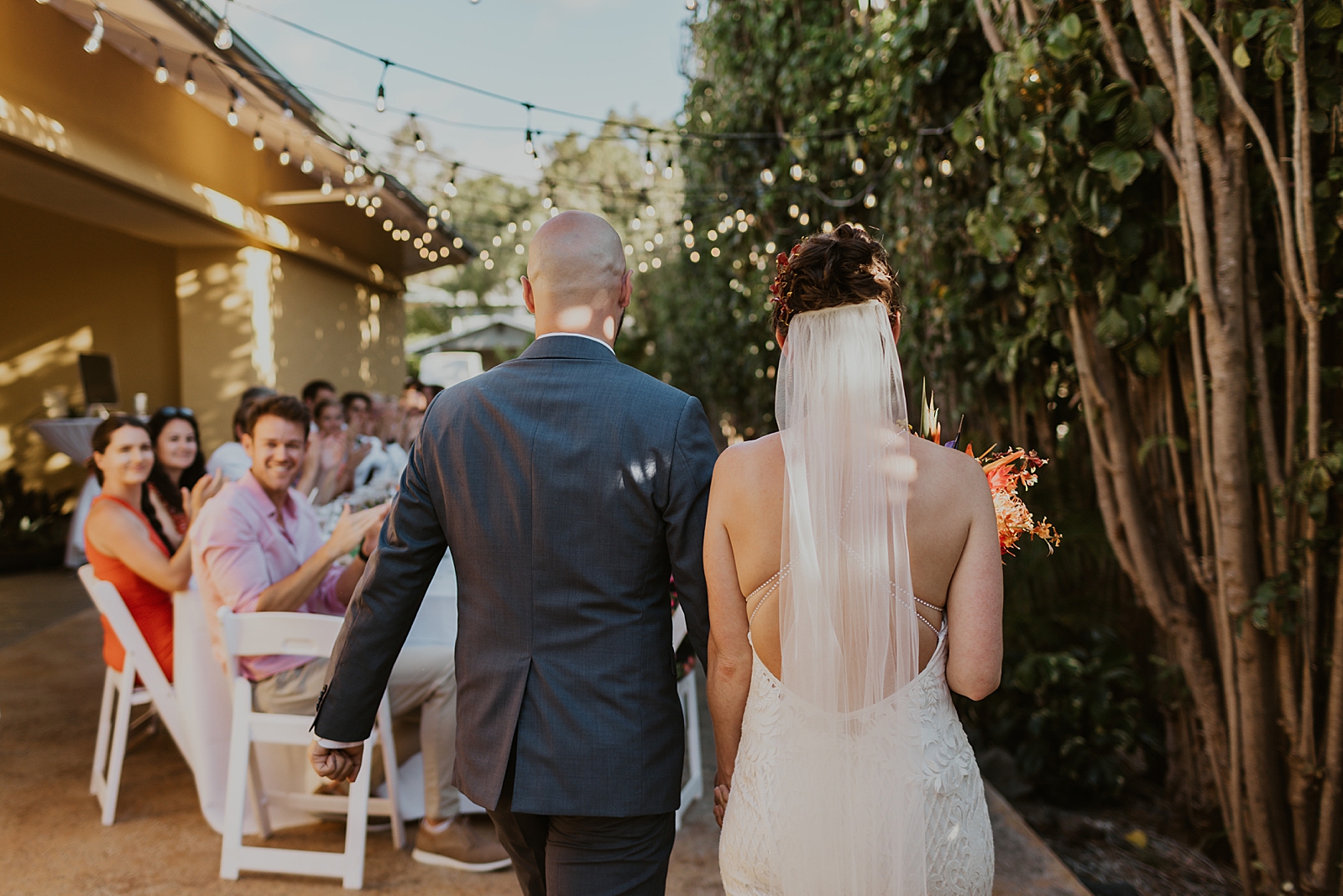 Bride and Groom entering intimate backyard Reception area