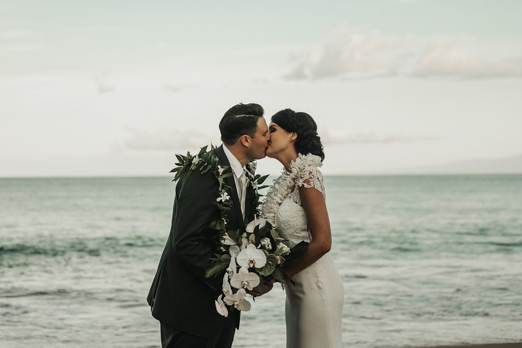 Bride and Groom kissing in front of the ocean