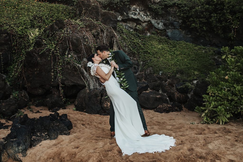 Bride and Groom dipping and kissing on the sand of the beach