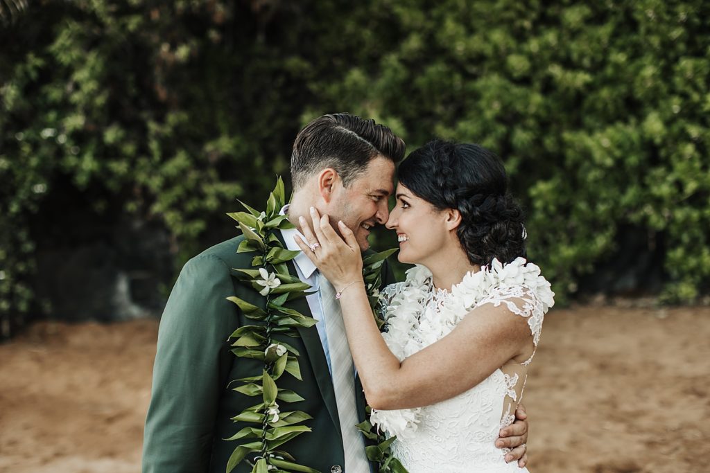 Bride and Groom touching noses on the beach