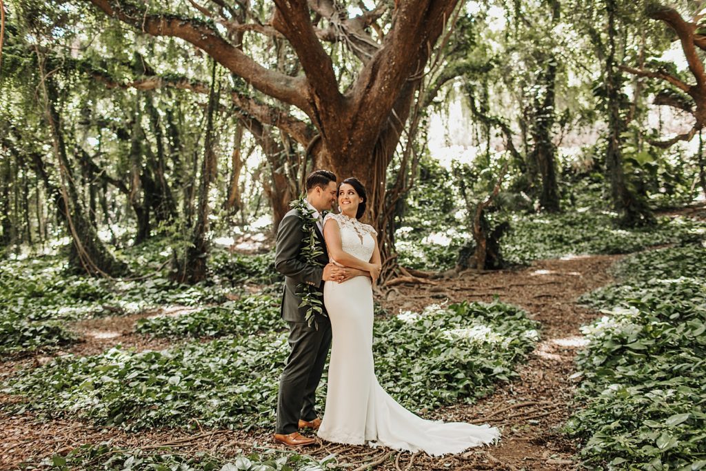 Bride and Groom hugging in the forest