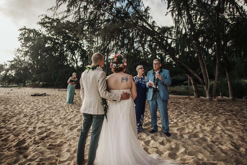 Bride and Groom together listening to parents