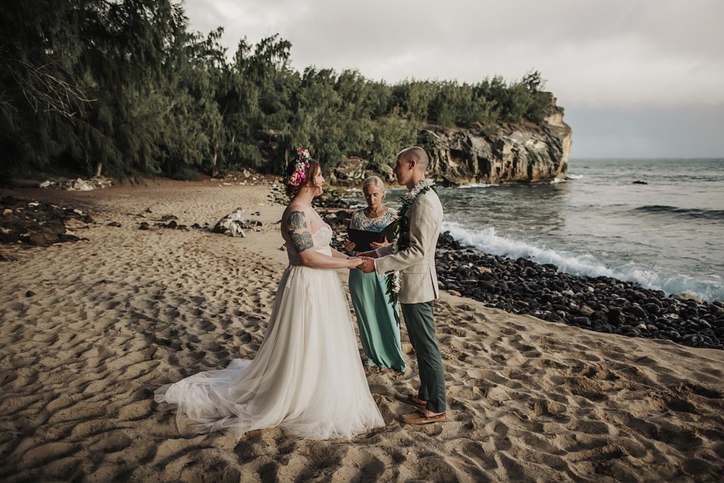 Bride and Groom hand in hand for formal vows for sand elopement